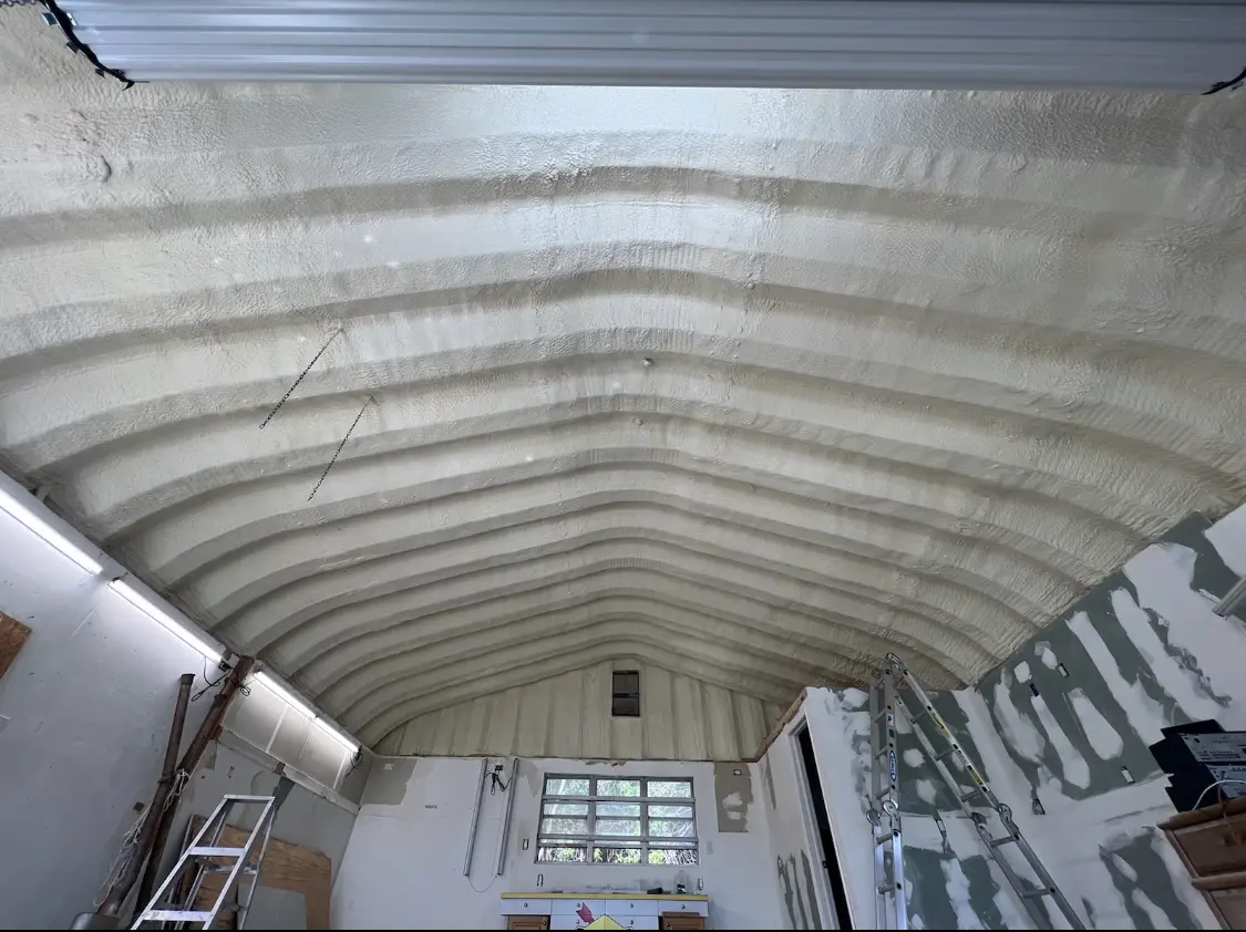 Spray polyurethane foam applied to the underside of a metal roof deck in Portales